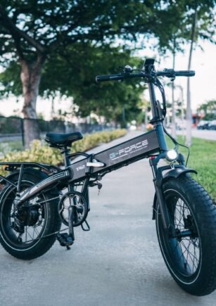 Sleek electric bike parked outdoors surrounded by greenery